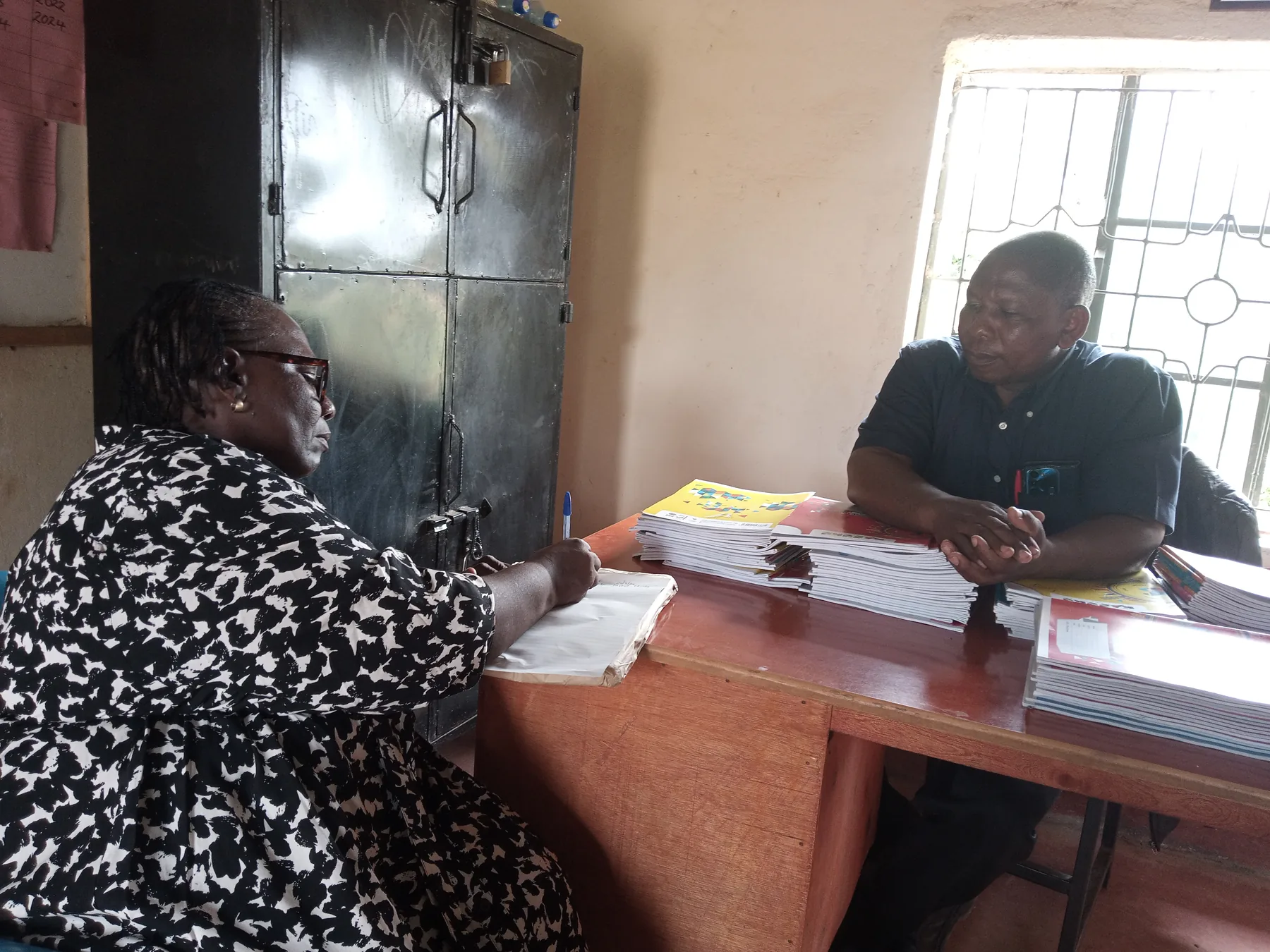 The Secretary, Md Sabina Obura discussing challenges that the Students go through and writing them down for future references.