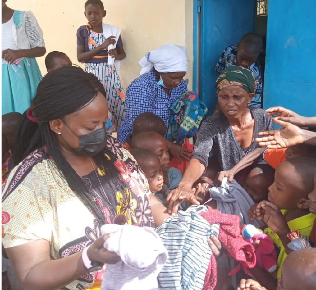 Distributing clothes to the AIC Baby Home Orphanage in Ngiluni.