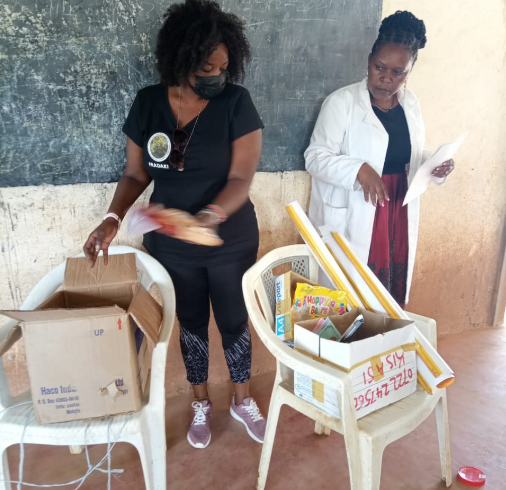 Distribution of class stationeries to the students in Ngiluni community school inside their classes.#FRADAKI