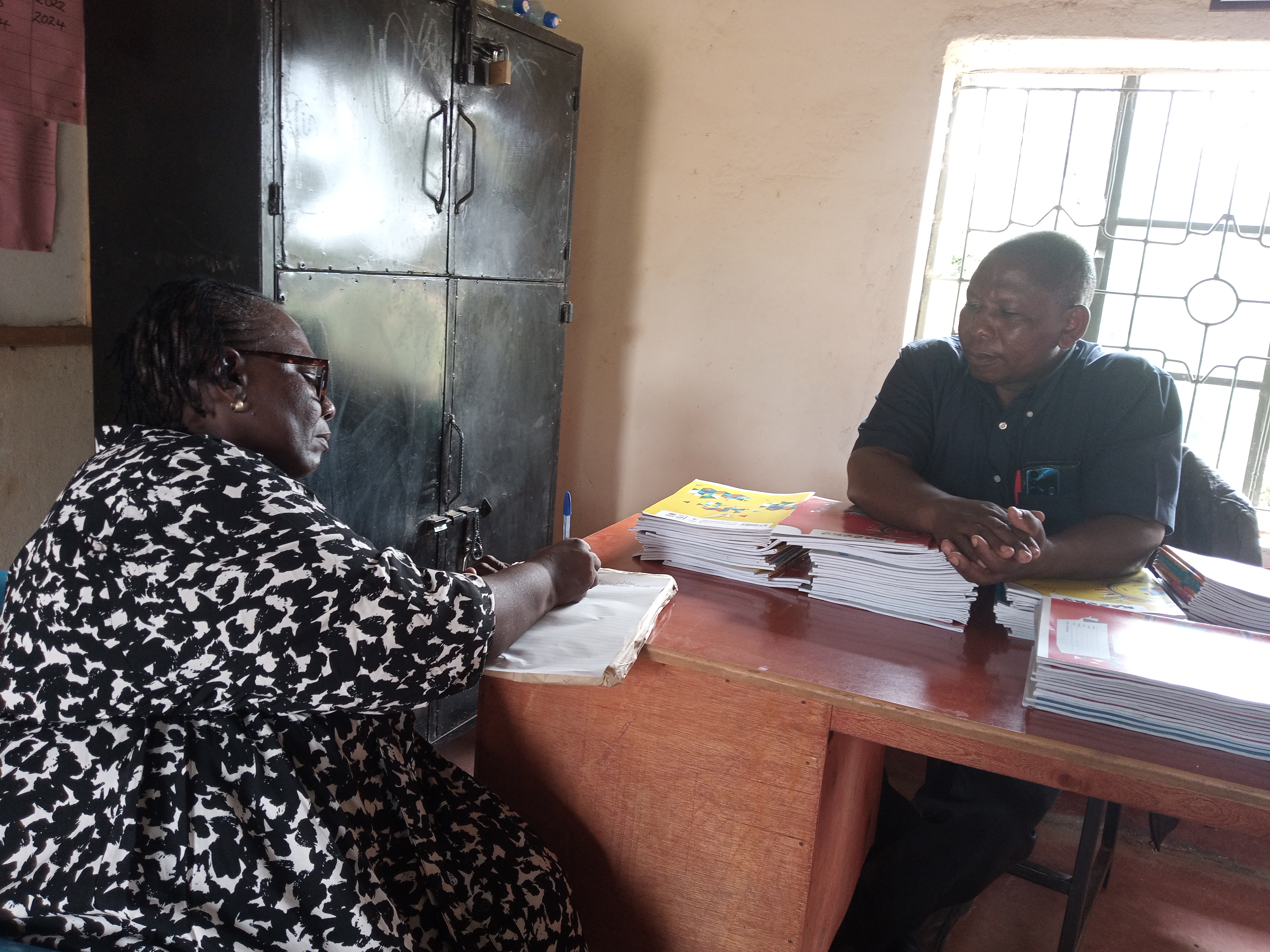 The Secretary, Md Sabina Obura discussing challenges that the Students go through and writing them down for future references. 