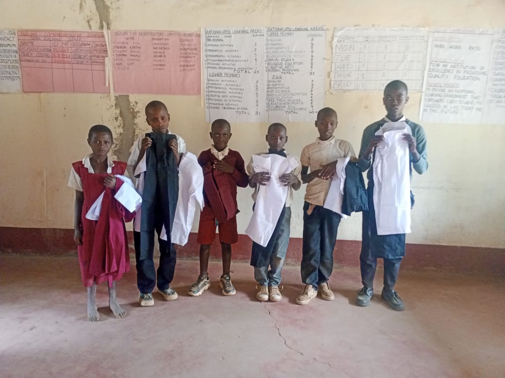 Needy Children of Ngiluni Comprehensive School receive new uniforms. 